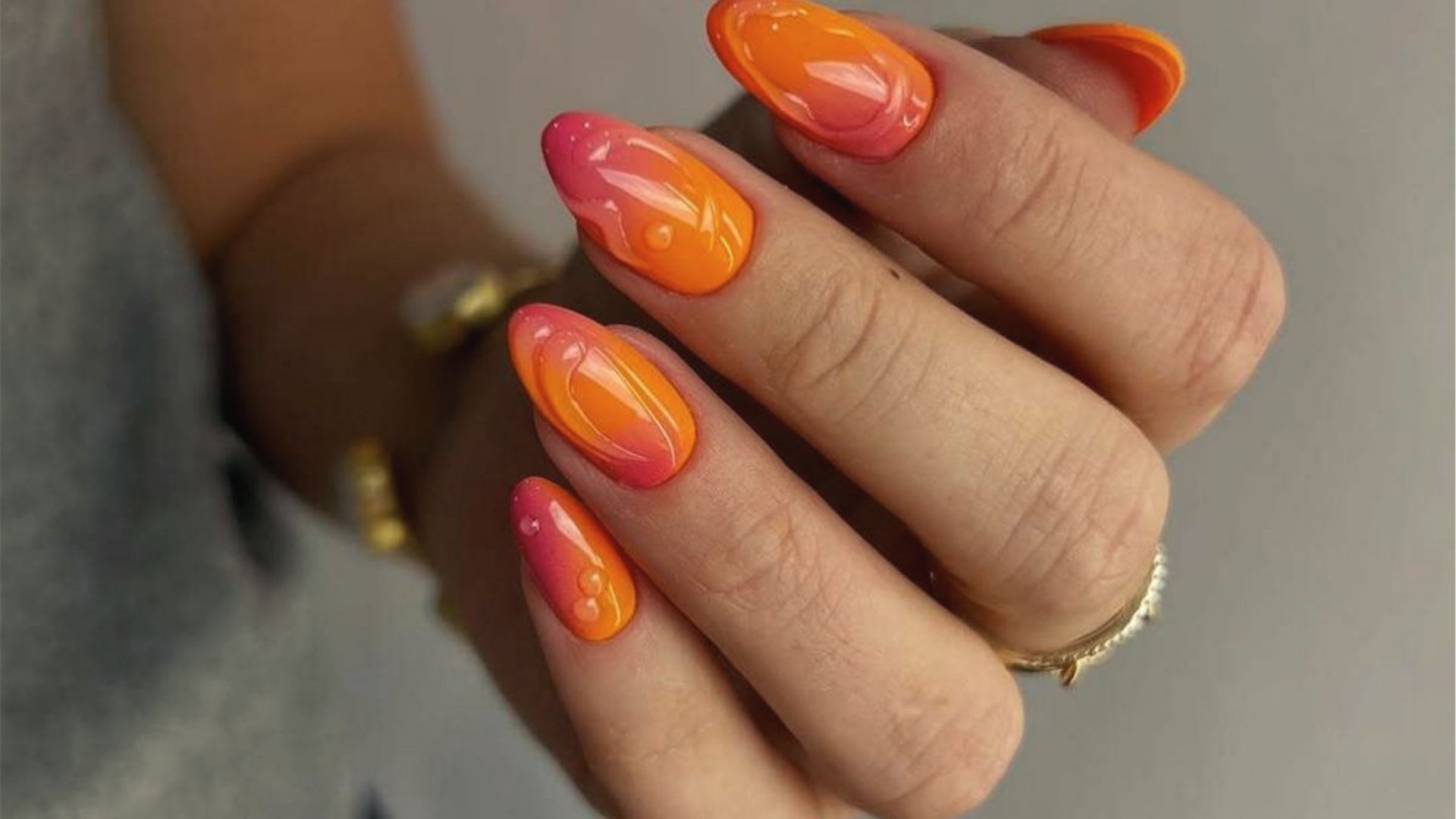 Almond nails with neon orange to pink ombre and 3D clear gel swirls, glossy summer nails.