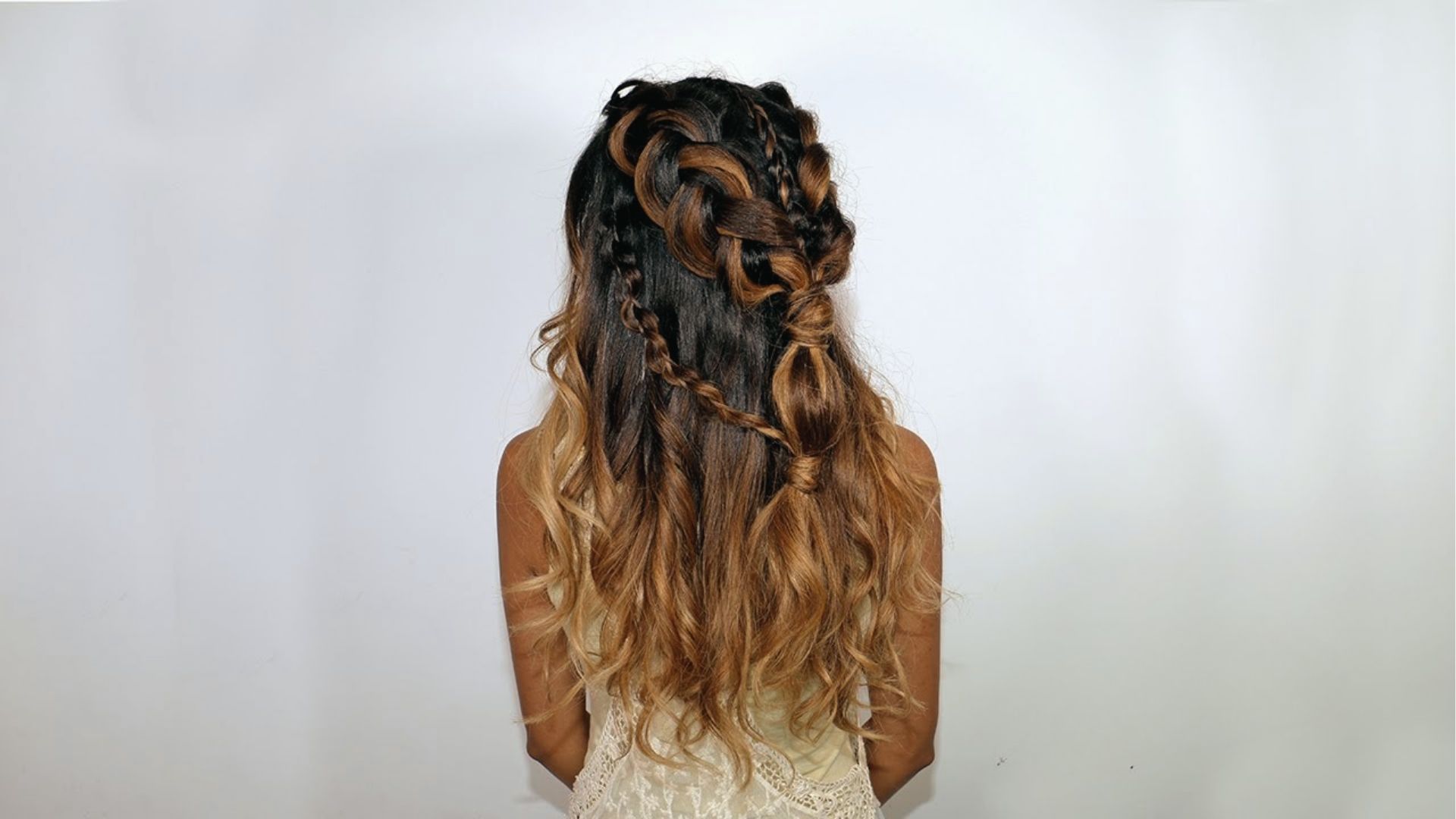 Intricate half up half down style on ombre hair with twists, knots, and loose waves in back