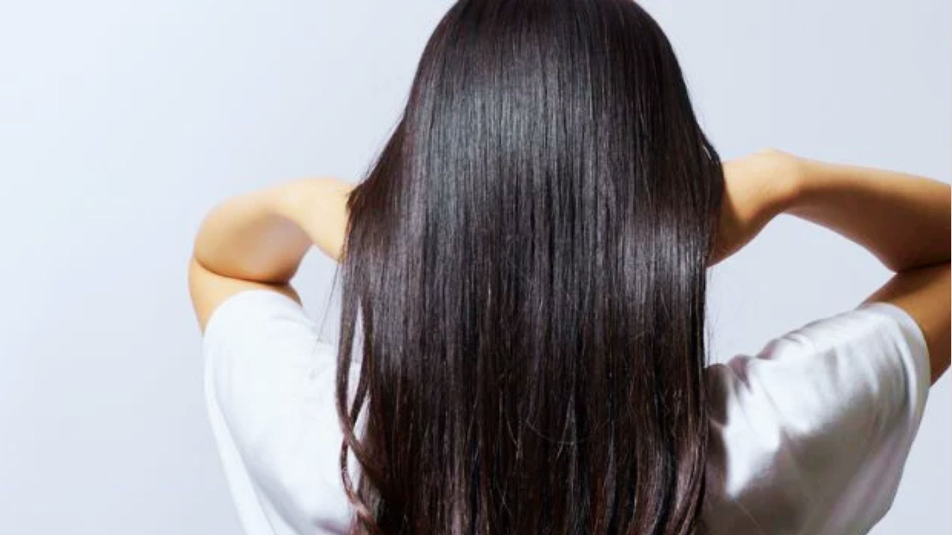 Rice water treatment applied to hair to improve softness, shine, and overall hair health