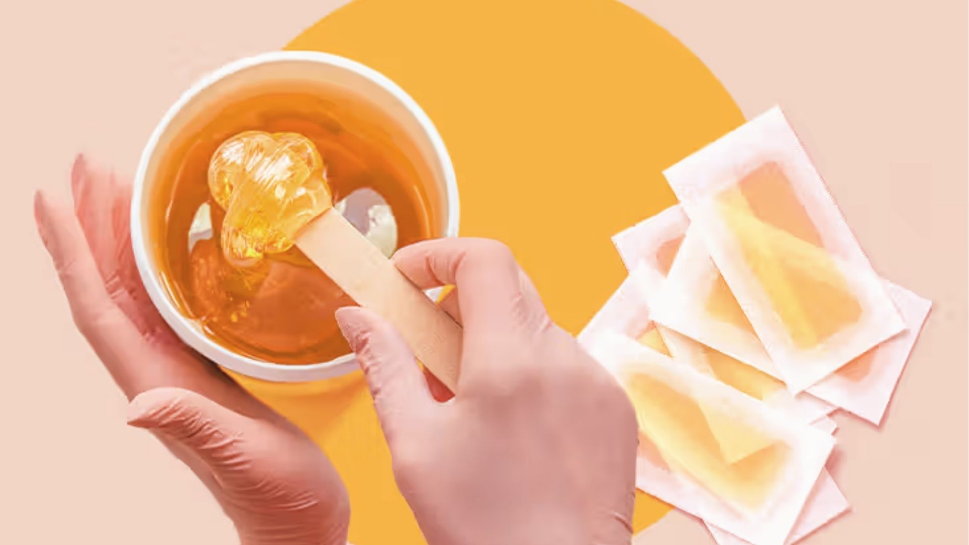 Gloved hands holding warm soft wax pots and strips for strip waxing large body areas.