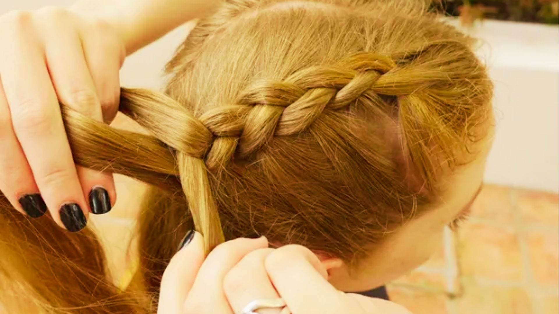 Raised Dutch braid with bold woven sections creating a thick three-dimensional hairstyle appearance from behind