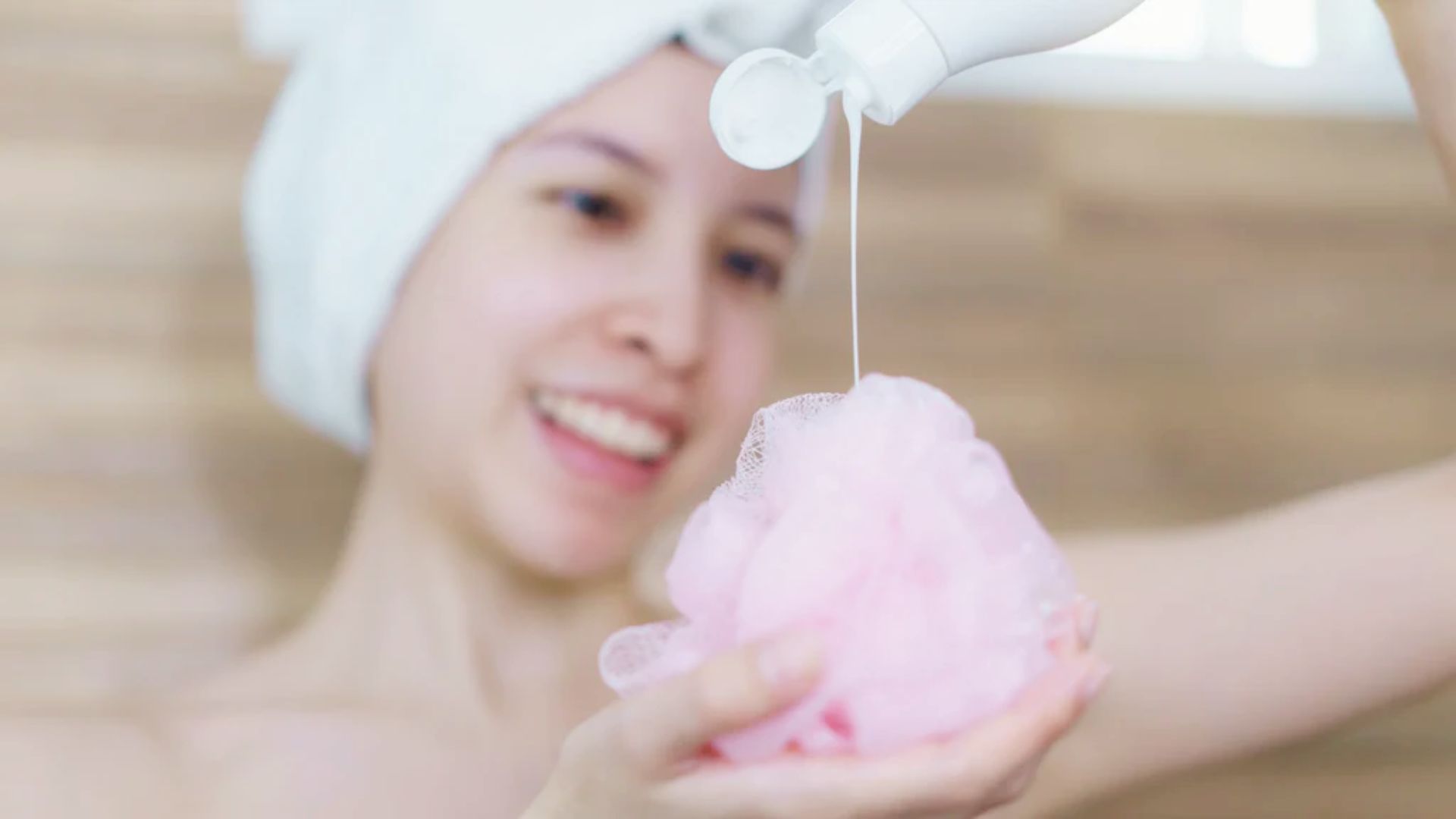 Woman using body wash in the shower for a gentle daily cleansing routine.