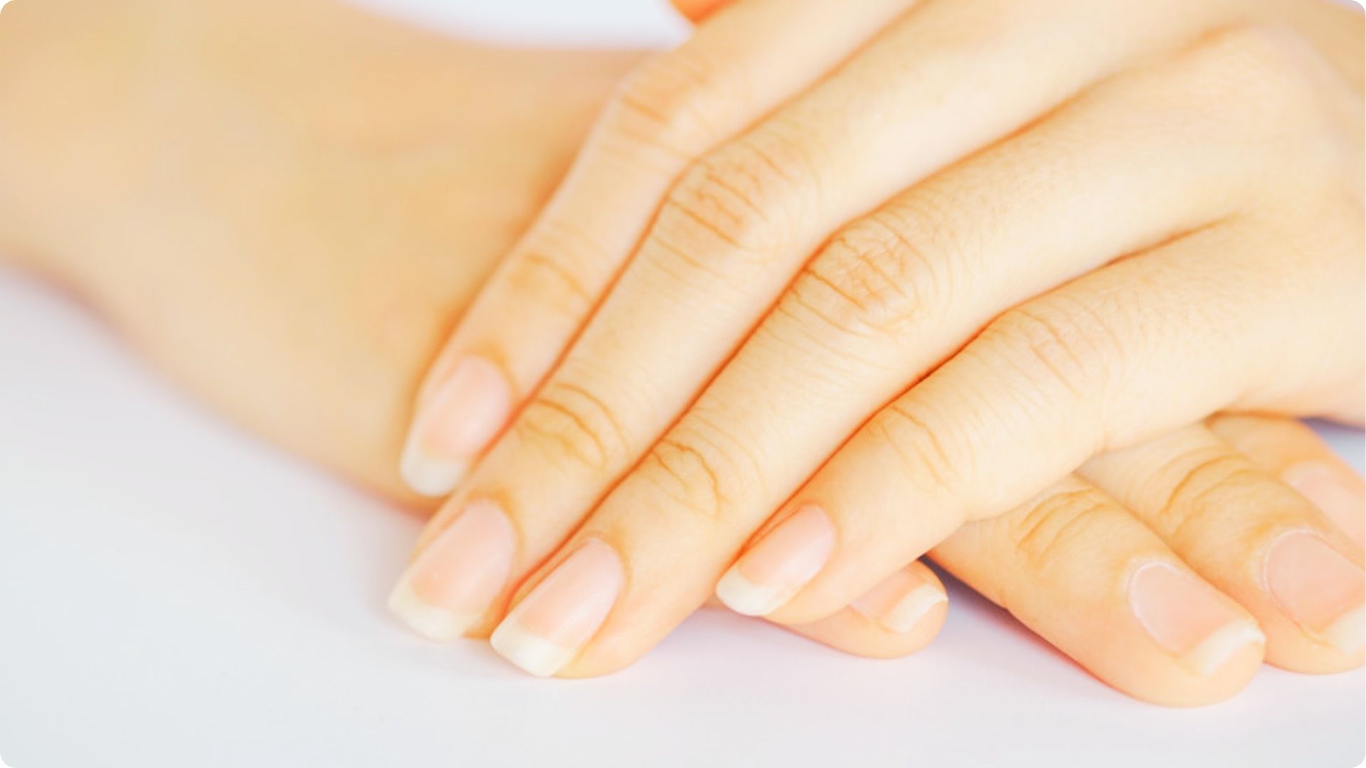 Close-up of hands with short, bare natural nails and no polish.
