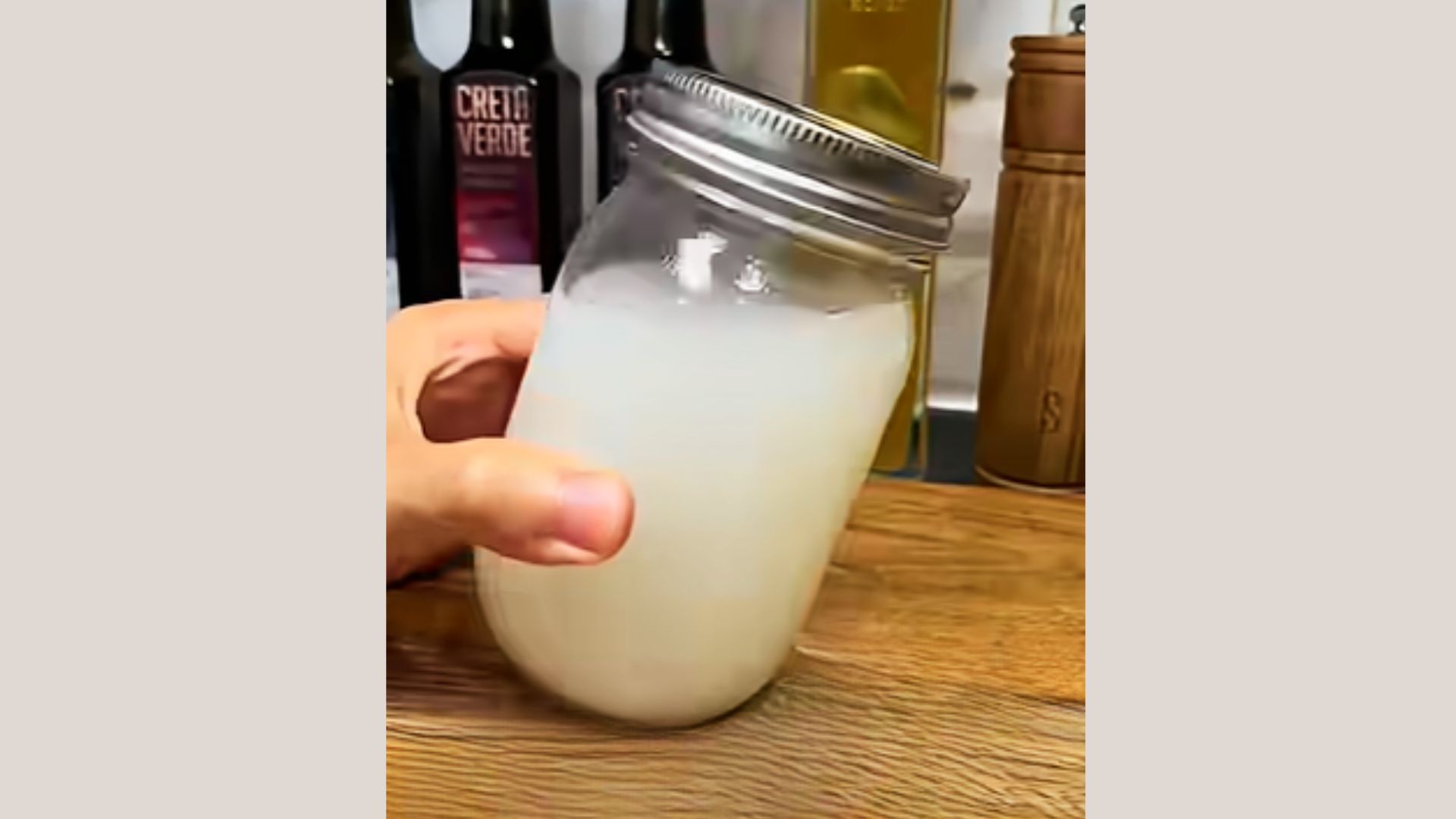 A glass container with rice water stored inside for hair care use