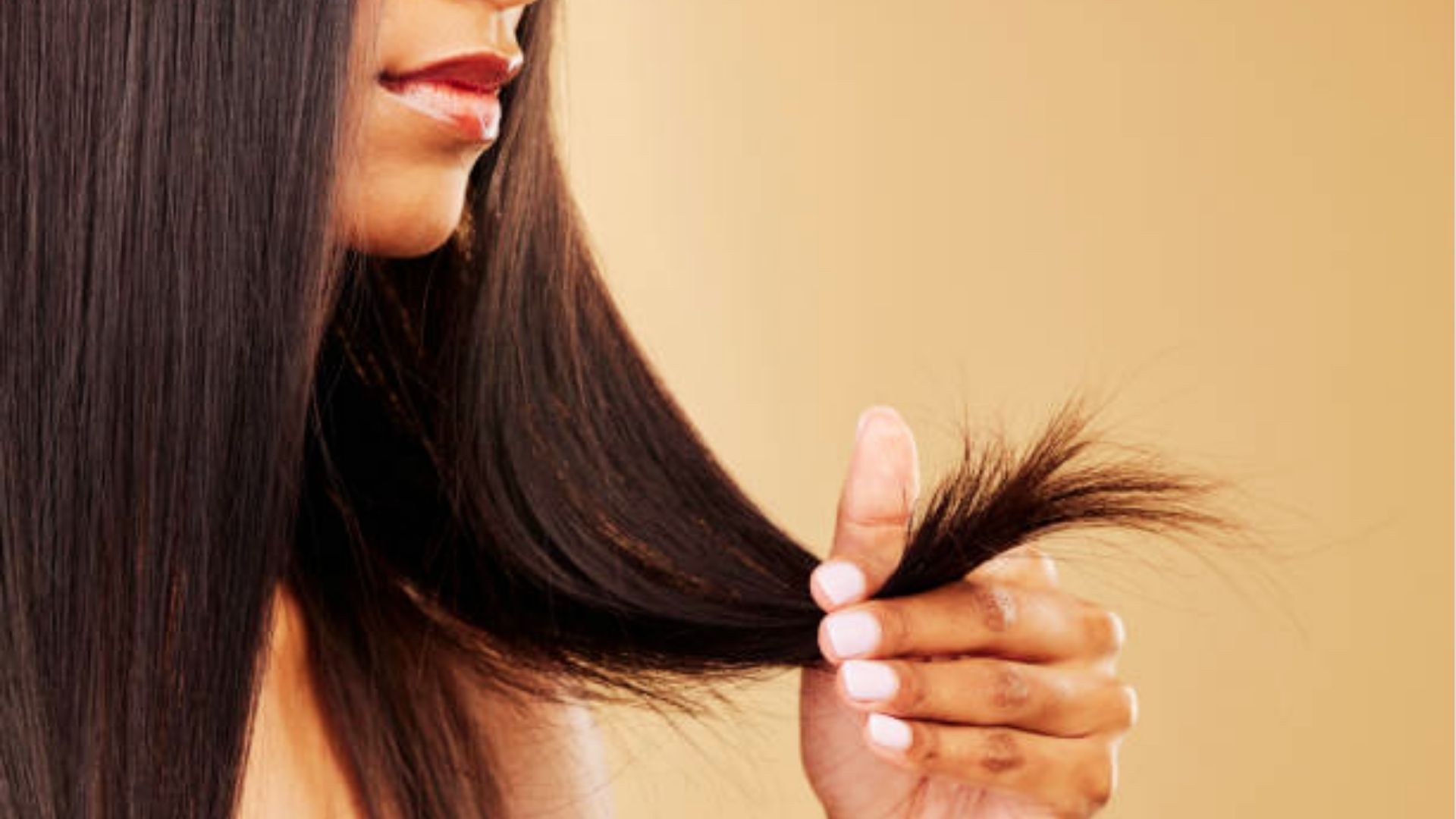 A girl looking at her hair while checking its condition and texture for rice water hair care routine