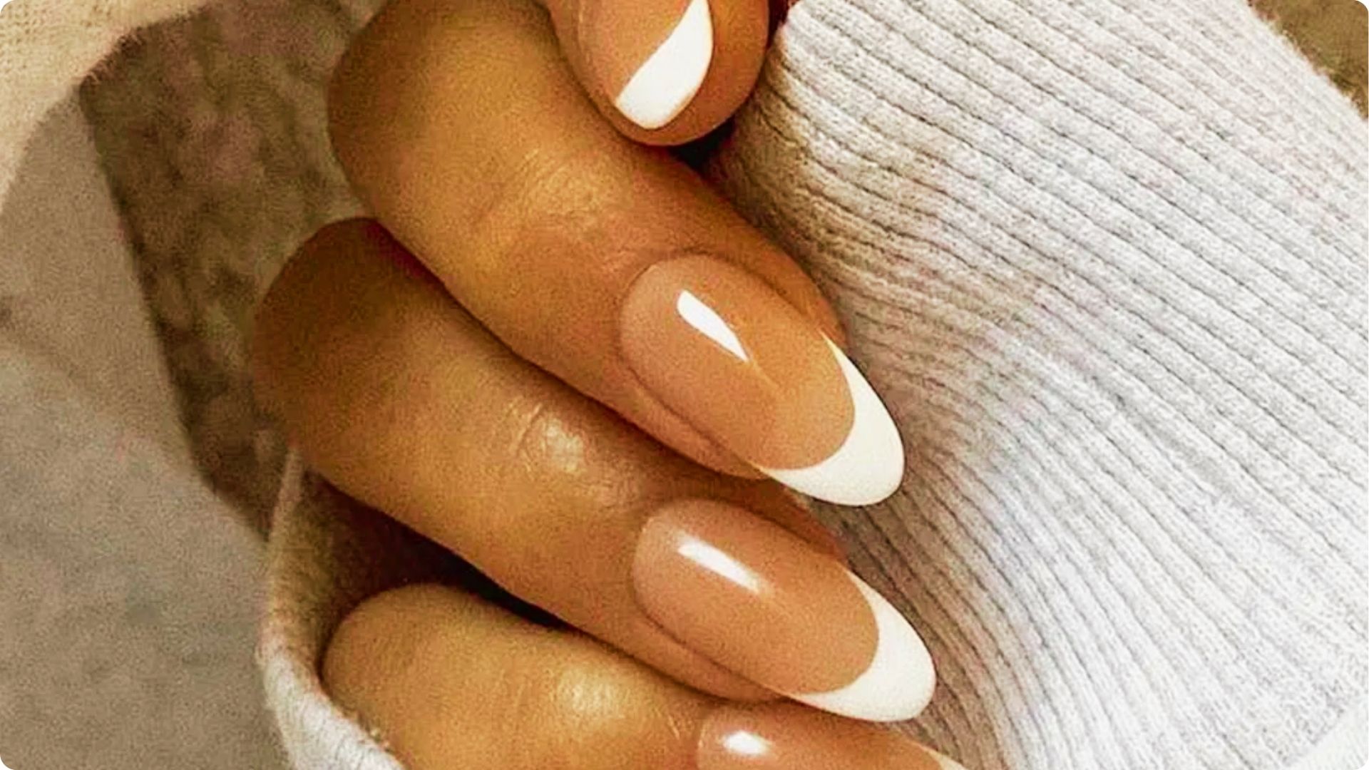 Hand slightly cupped showing oval-shaped nails with glossy light pink polish.