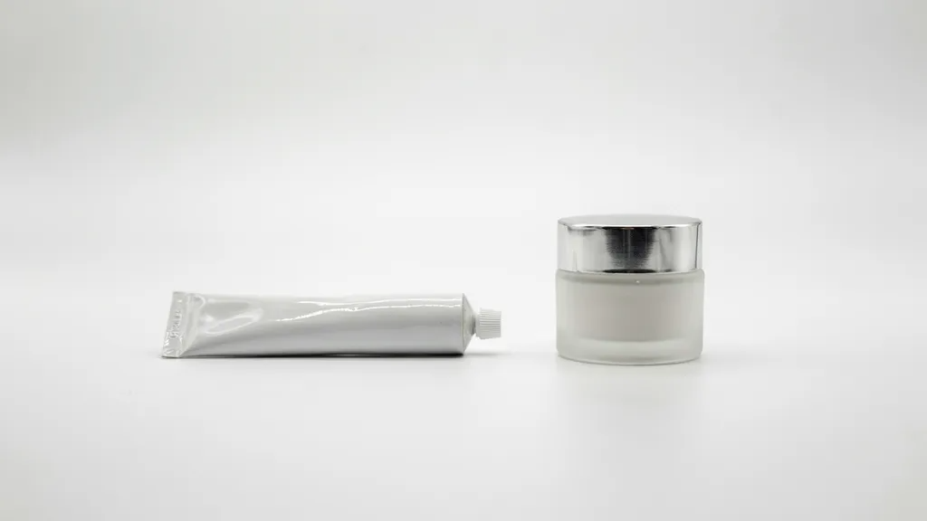 Close-up of prescription cream being applied during dermatology treatment for dark elbows.