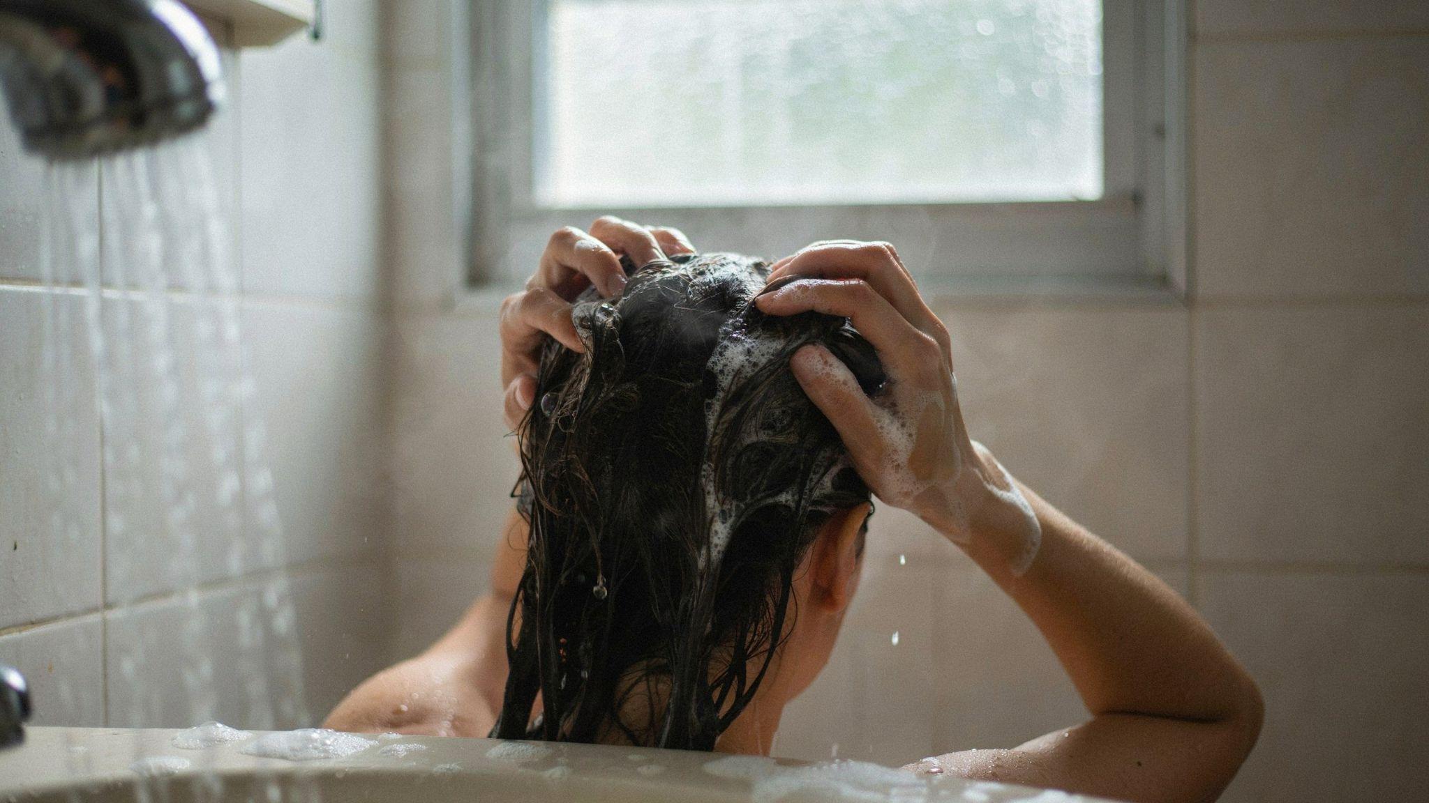 Person using anti-dandruff shampoo to remove semi-permanent hair dye.