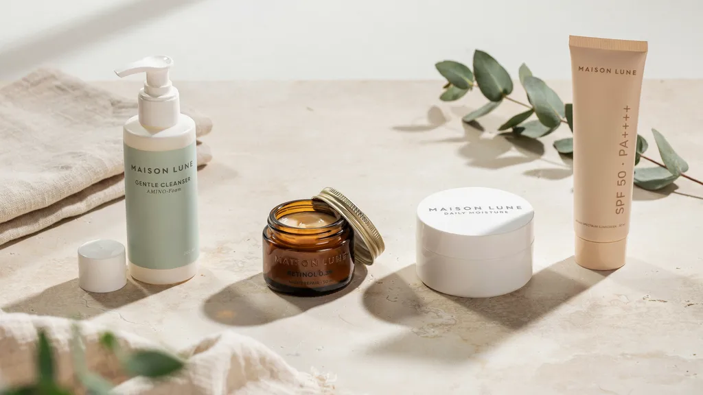 Beginner skincare routine with cleanser retinol moisturizer and sunscreen arranged neatly on clean background.