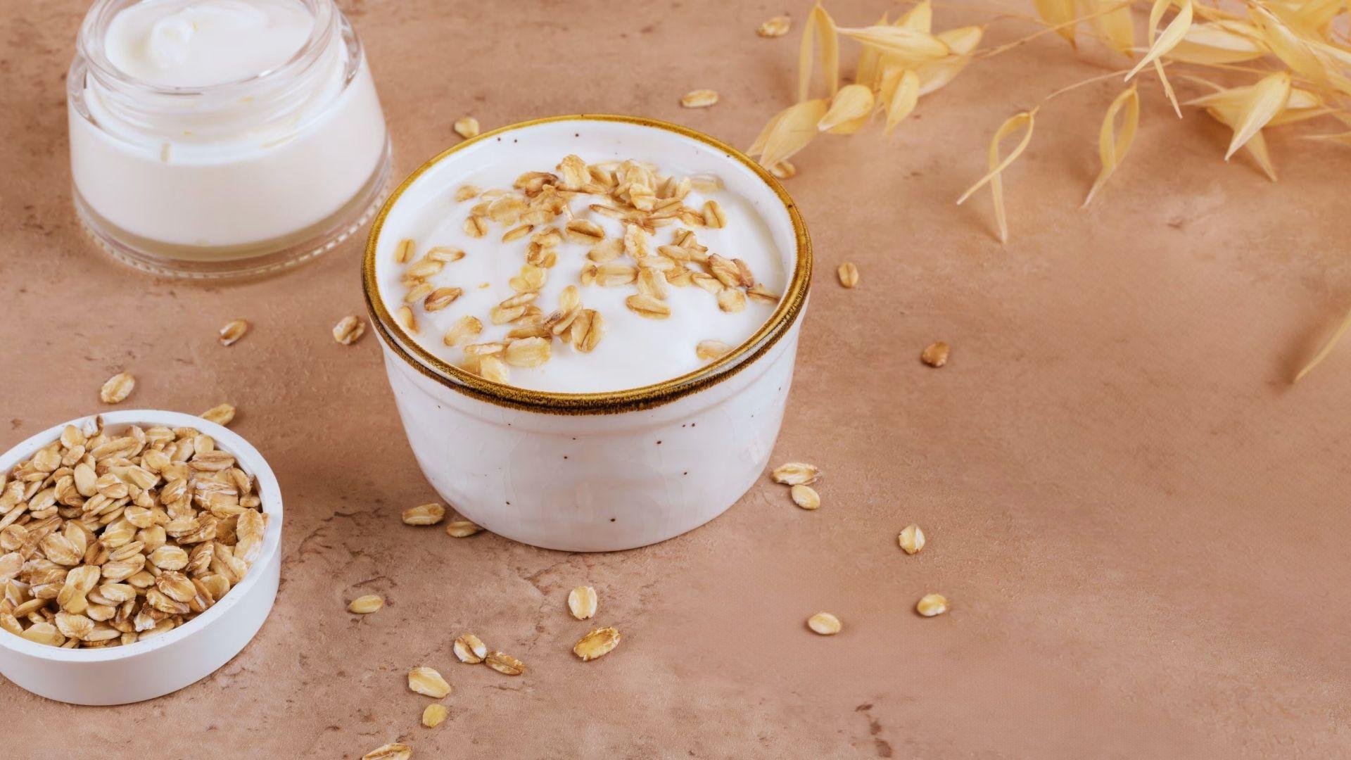 Close-up of oatmeal and yogurt mixture in a bowl used for skin exfoliation.