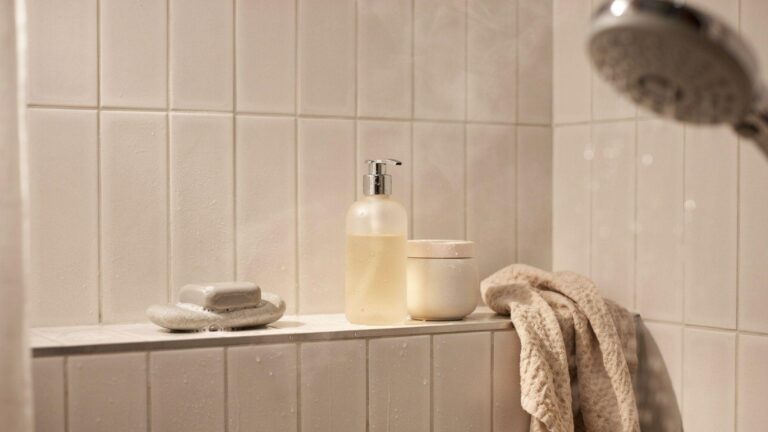 Bathroom shelf showing shampoo and body wash used for comparison in shower routine.