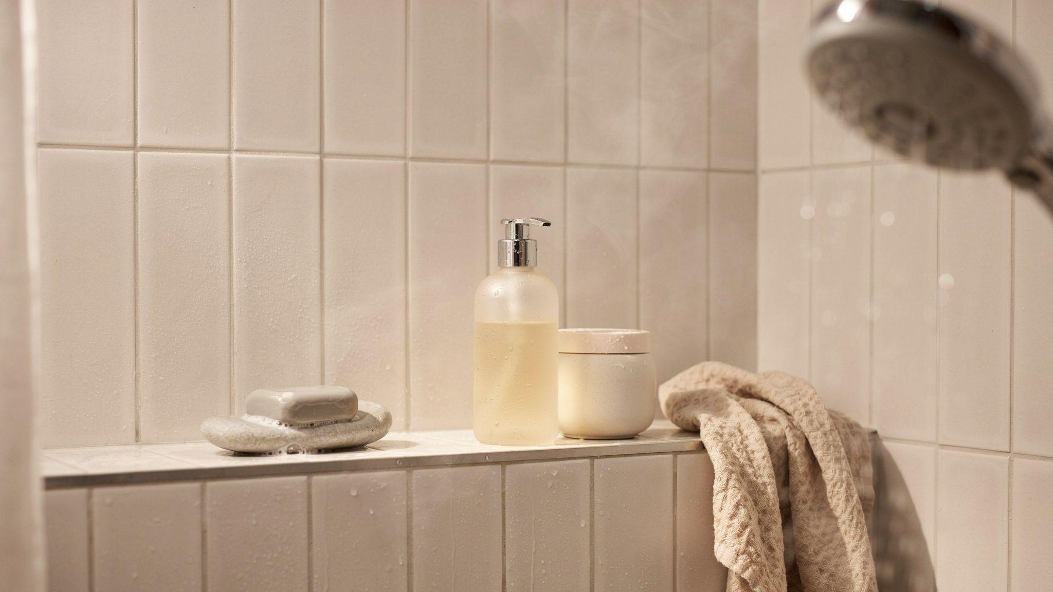 Bathroom shelf showing shampoo and body wash used for comparison in shower routine.