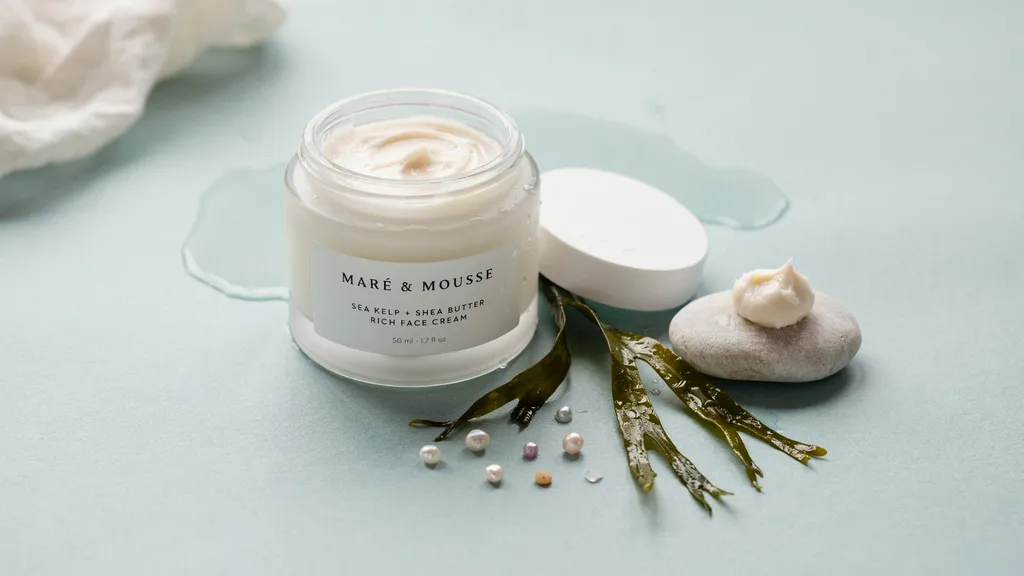 Sea culture face cream with sea kelp and shea butter arranged on a clean minimal blue toned background.