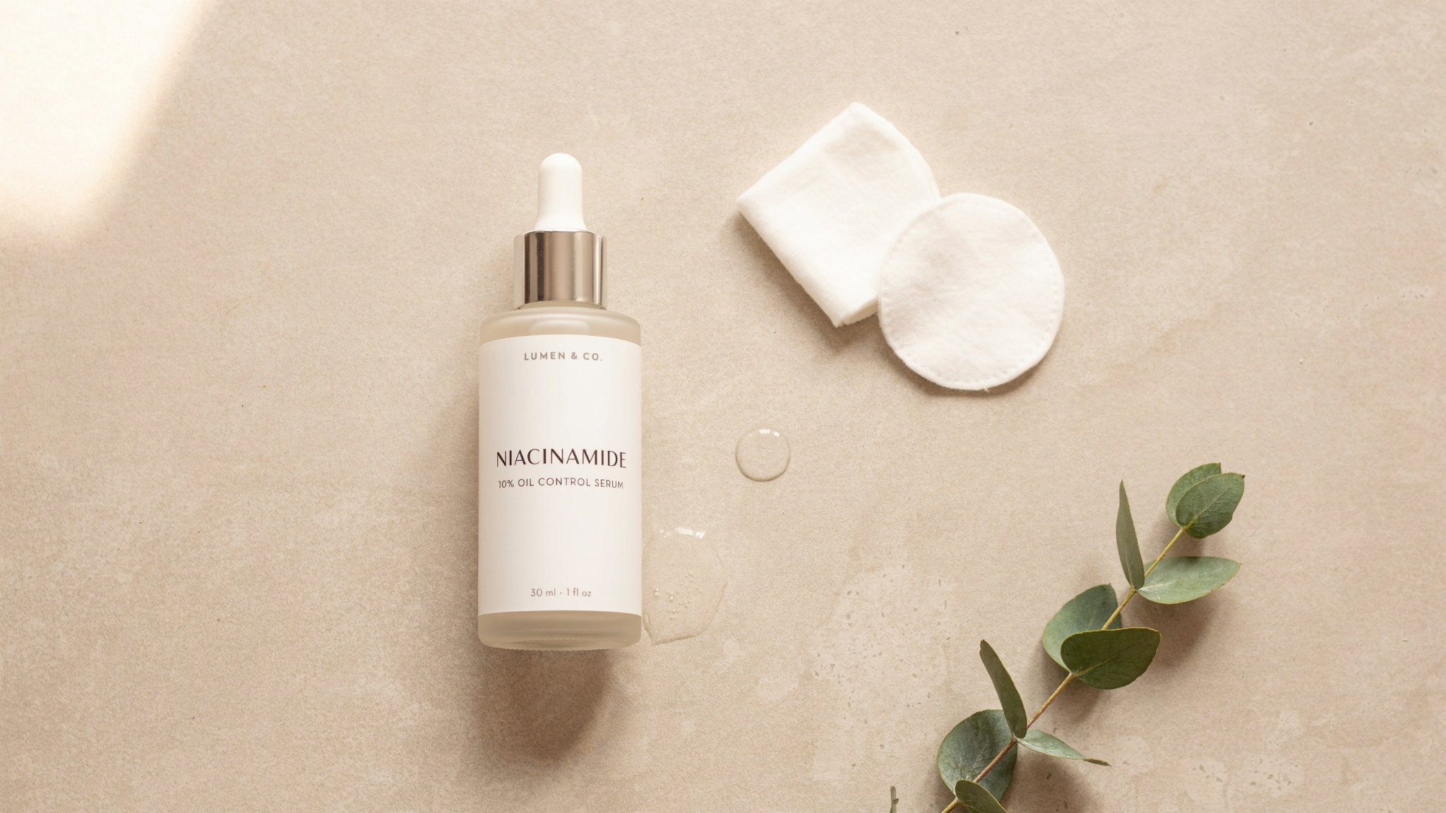 niacinamide serum bottle on clean surface representing oil control reduced pores and improved skin tone with balanced skincare routine benefits shown.