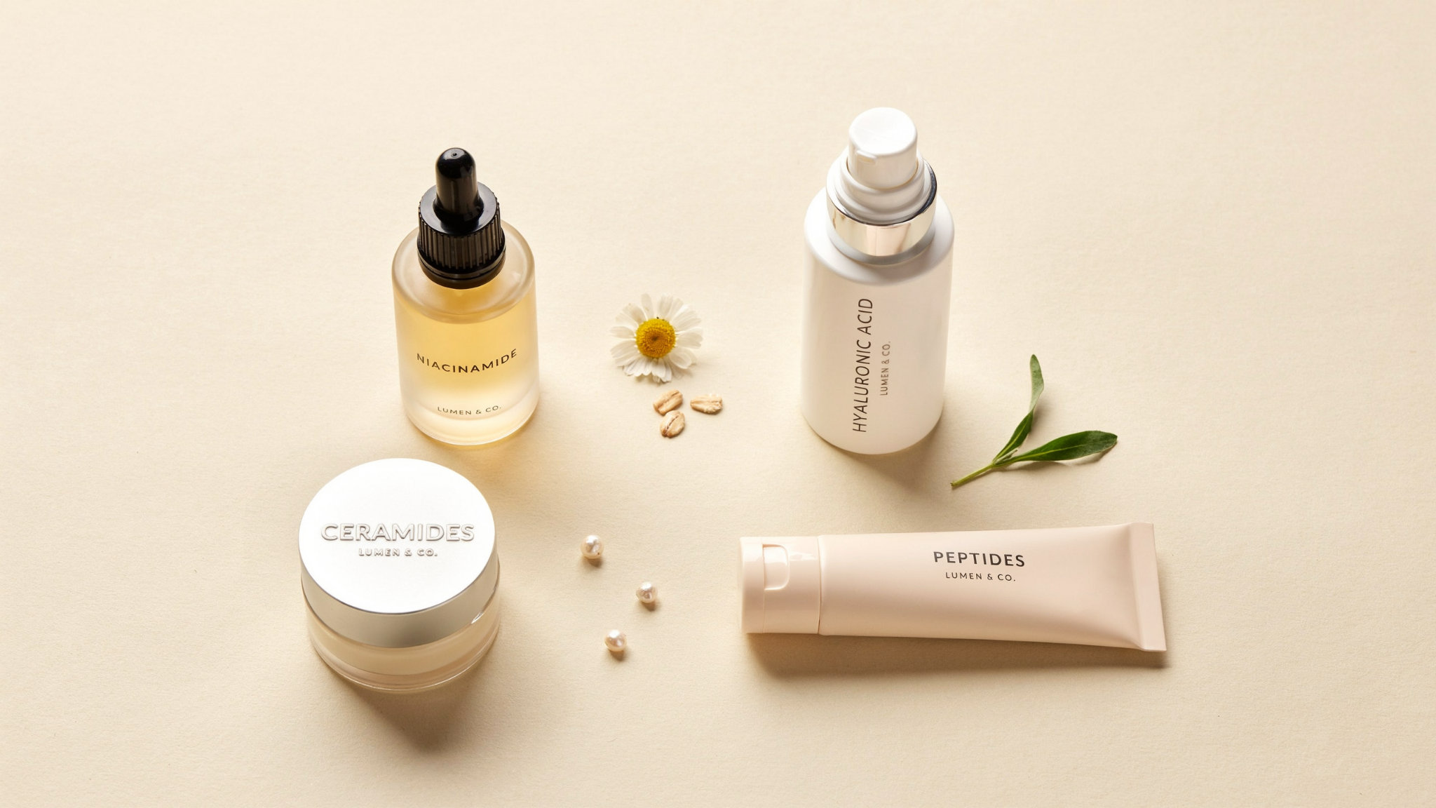 Skincare ingredients like niacinamide hyaluronic acid ceramides and peptides arranged neatly on a minimal clean background.
