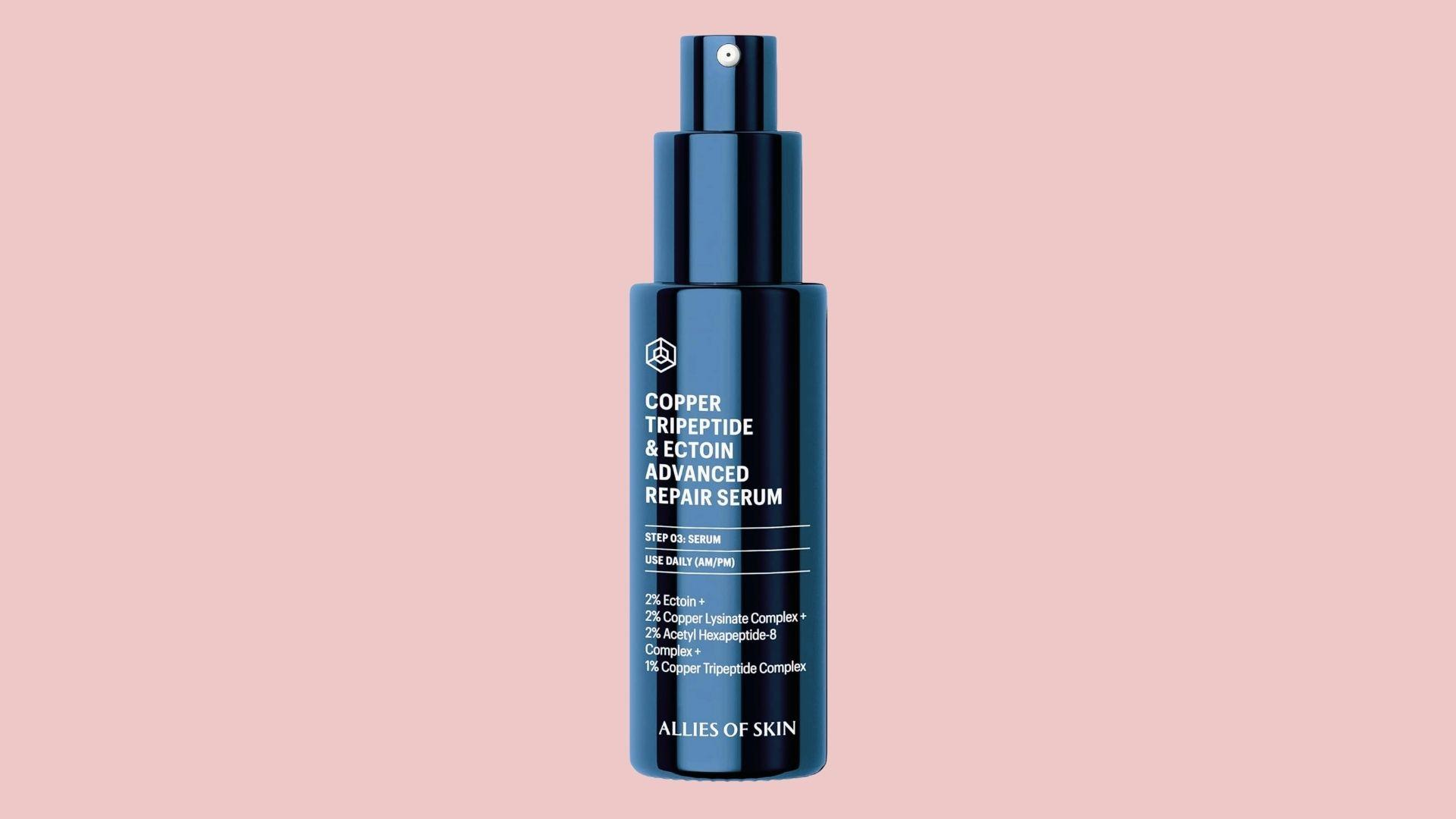 Allies of Skin Copper Tripeptide and Ectoin Advanced Repair Serum dark blue pump bottle on pale pink background