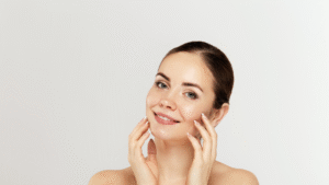 A joyful woman holds her face with her hands, showcasing a warm and inviting smile.