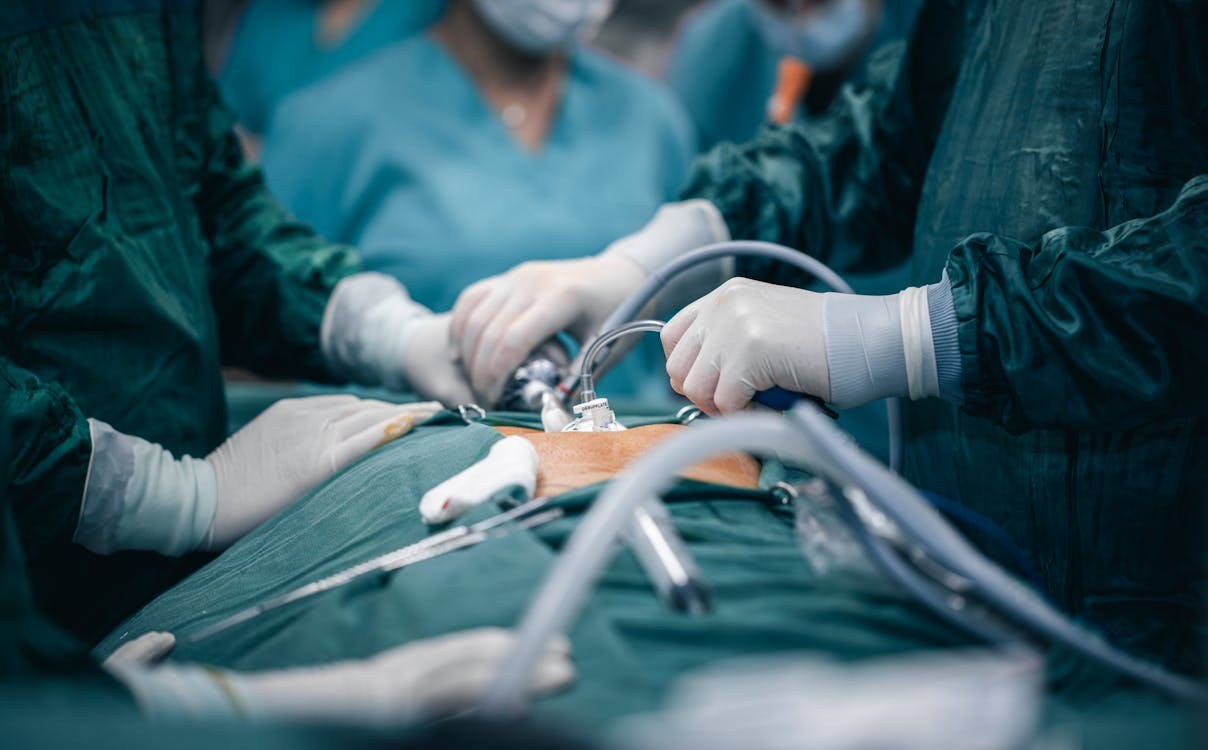 A surgeon skillfully performs surgery on a patient, surrounded by medical instruments and a sterile surgical team.