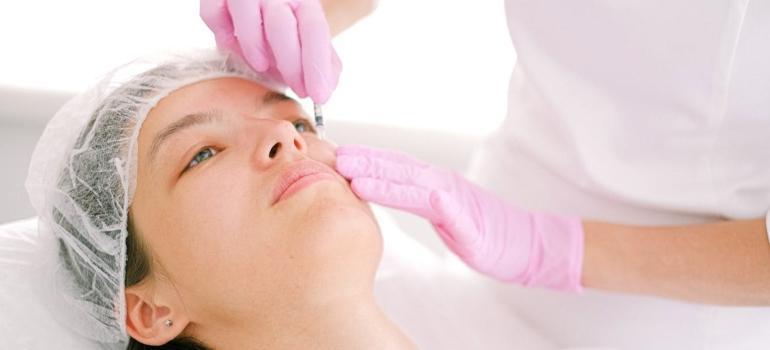 a woman having a facial treatment with injections