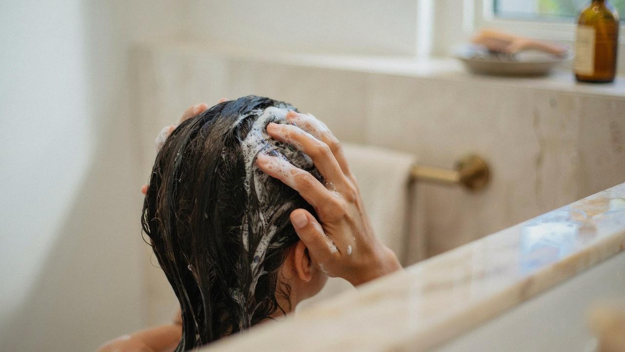 Gentle scalp massage during hair washing.