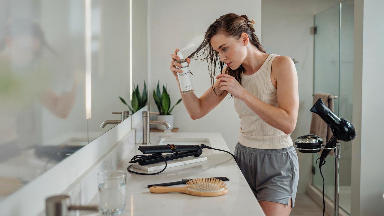 Proper hair preparation before heat styling with heat protectant and temperature control.