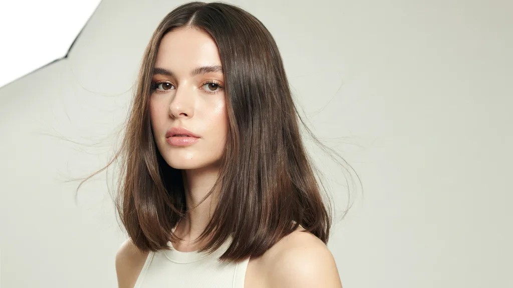 Butterfly cut hairstyle with soft layered and flowing hair movement.