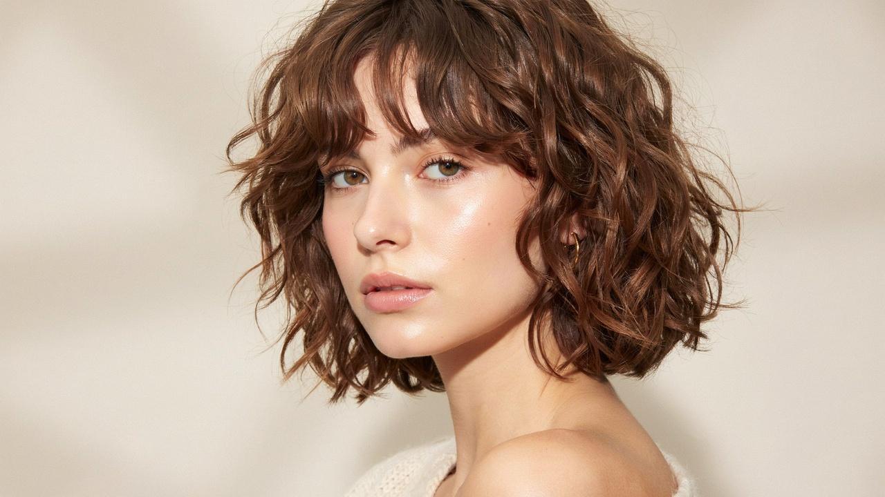 Curly shaggy layered bob with defined curls.