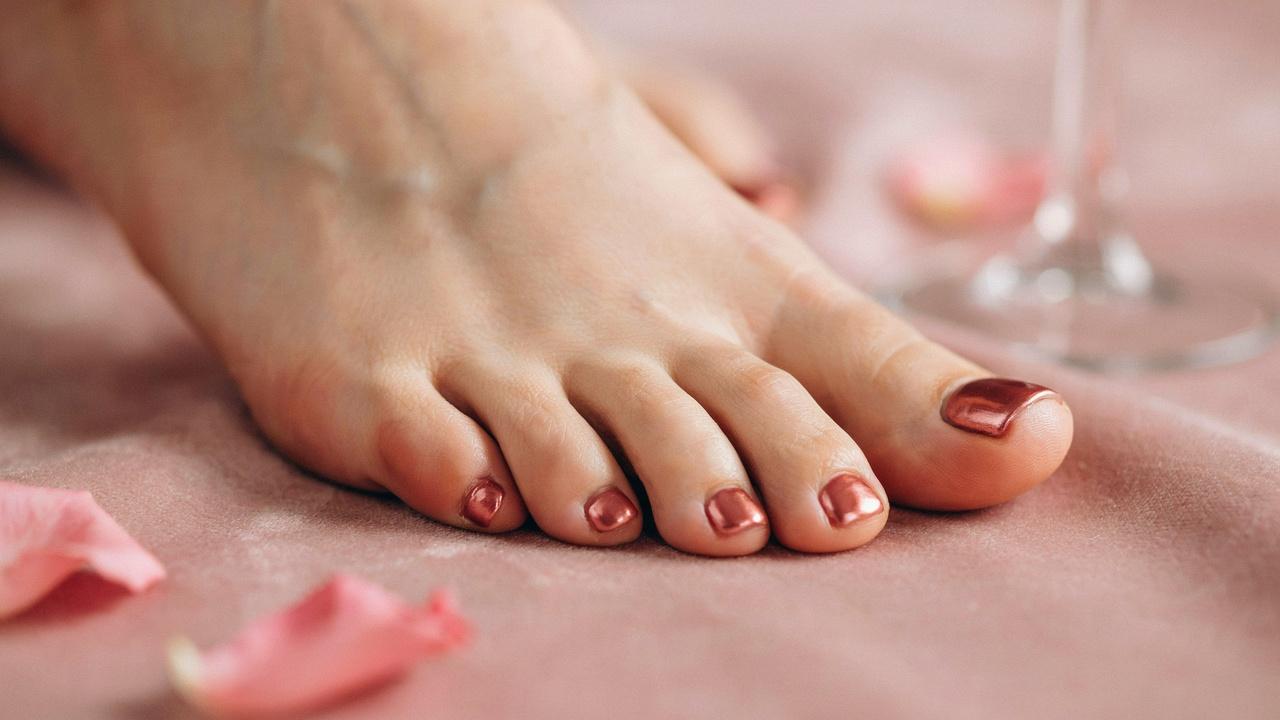 Rose gold chrome pedicure with a reflective metallic finish.