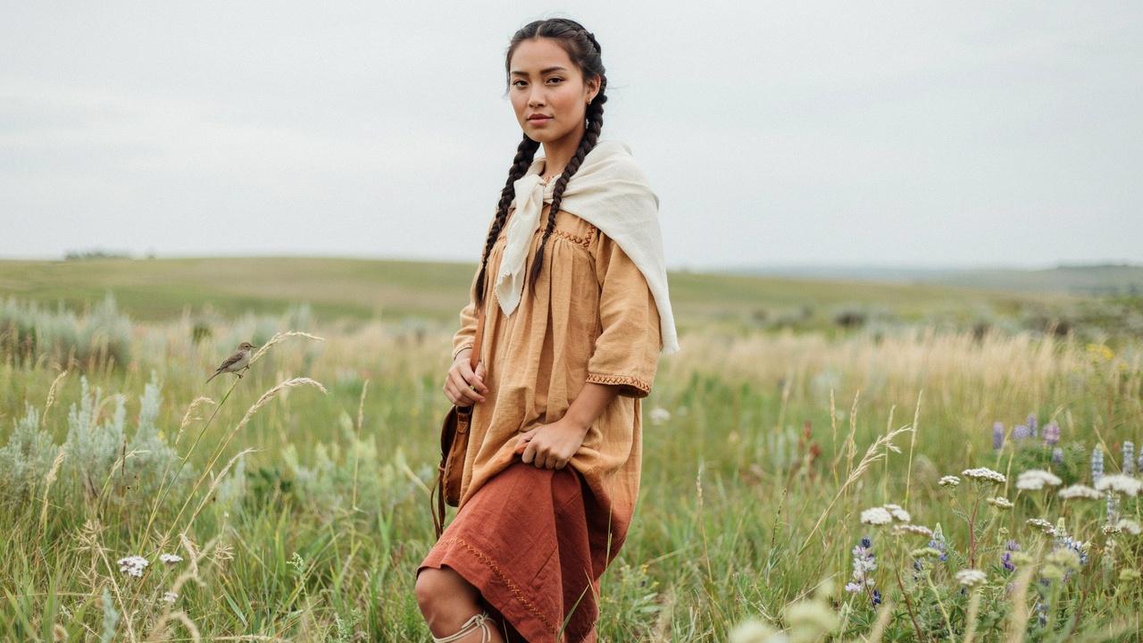 Double braided hairstyle inspired by Native American traditions.