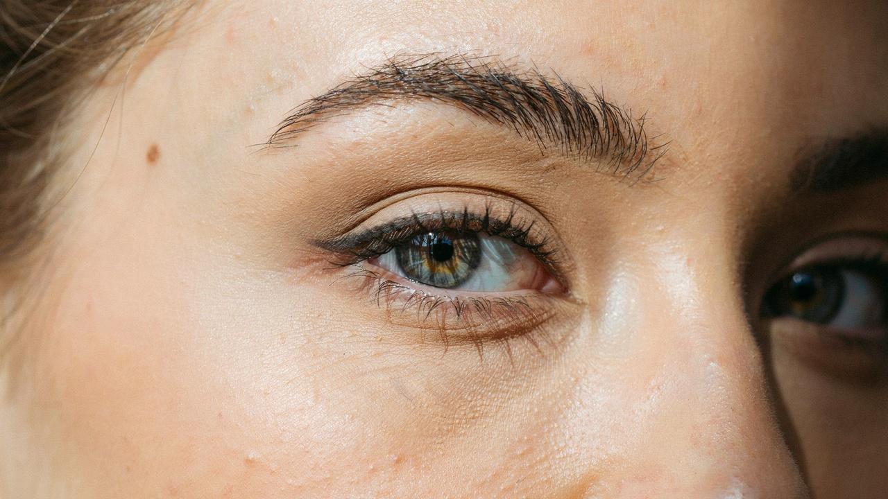 Bold thick permanent eyeliner creating dramatic eye definition.