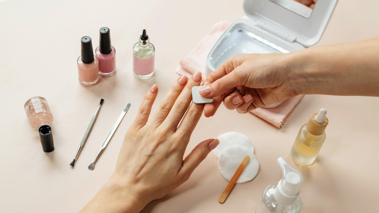 Glossy, long-lasting gel nails with manicure tools and proper nail prep steps to prevent gel polish peeling.