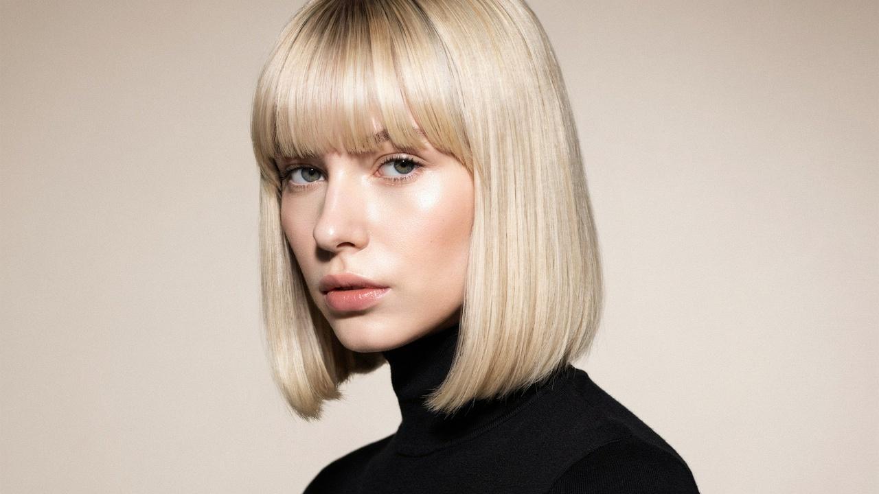 Woman with bob haircut and matching bangs.