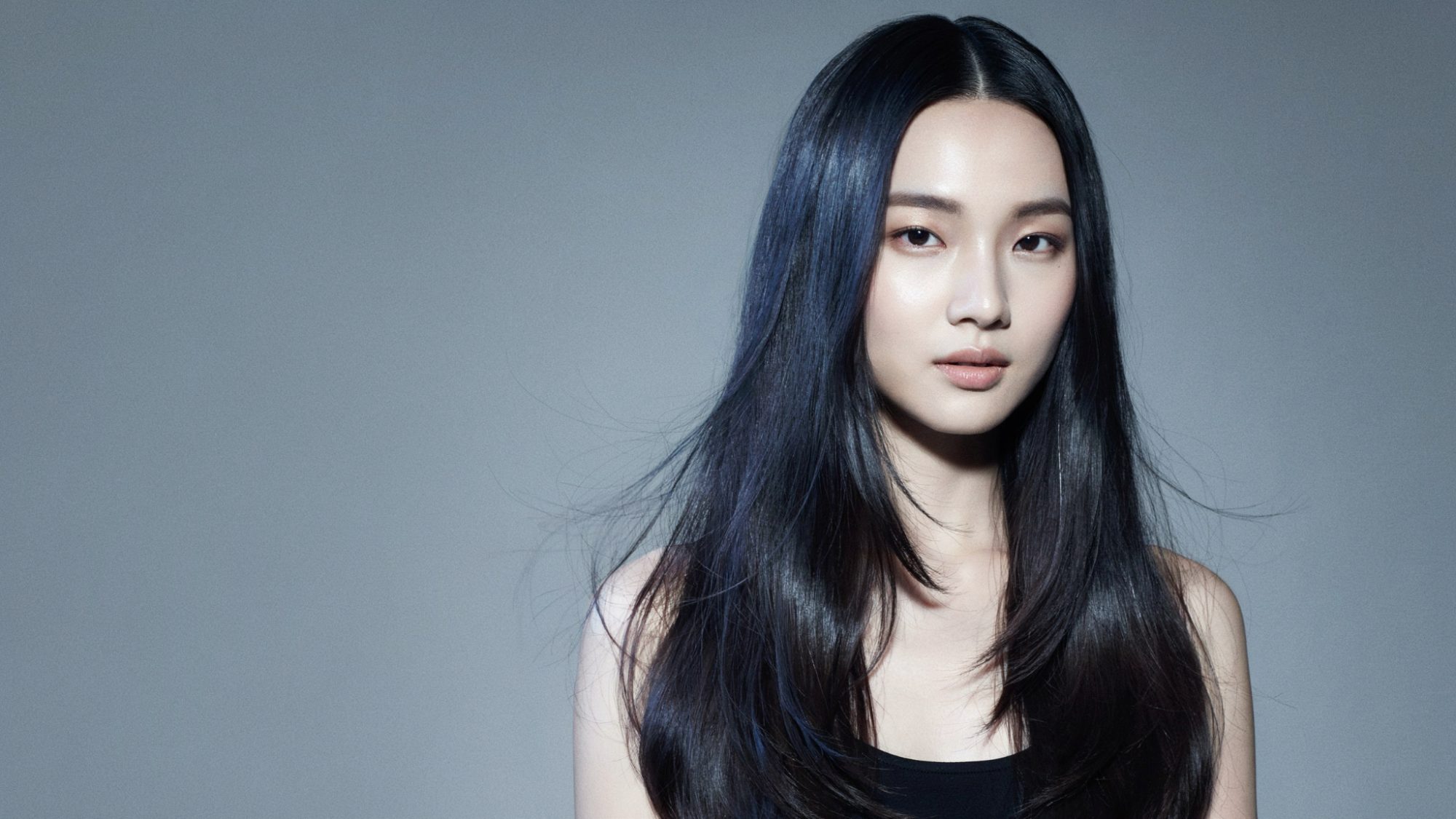 Blue black hair showing subtle cool blue undertones in light.