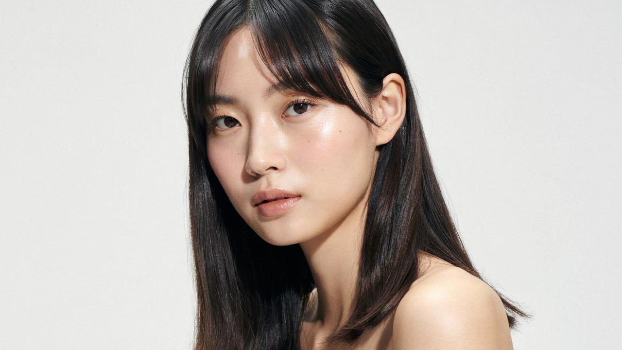 Woman with crescent bangs featuring a curved fringe shape.