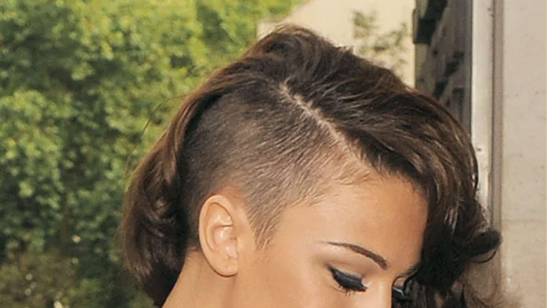Profile of woman with Curled Undercut Hairstyle, wavy brown hair, winged eyeliner