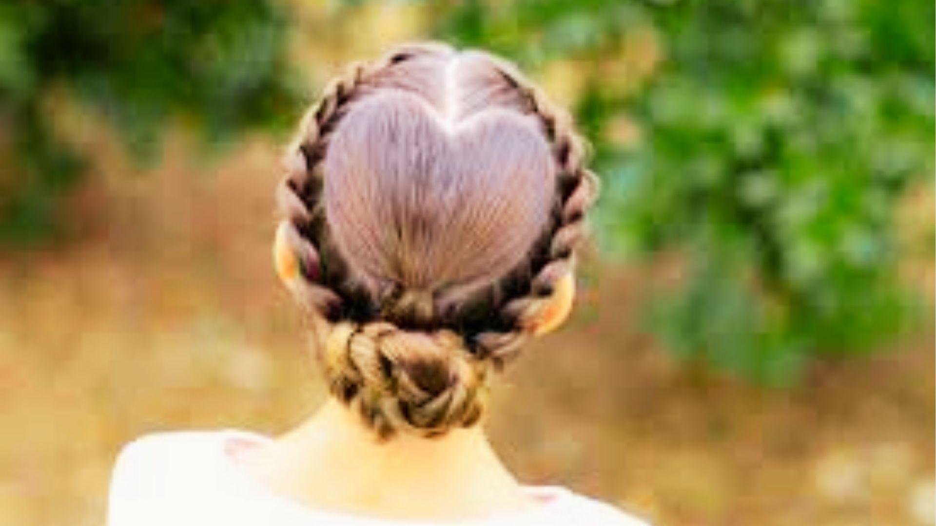 white girl wearing braided bun hairstyle featuring creative heart-shaped cornrow braid design beautifully styled